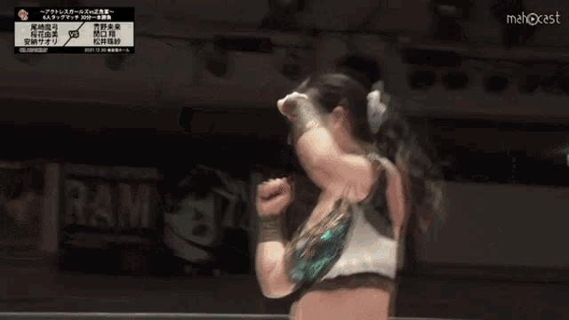 a female wrestler is giving the middle finger during a match