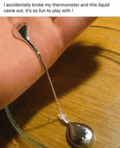 a person 's hand with a drop of liquid coming out of it .