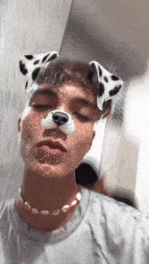 a man wearing dalmatian ears and a pearl necklace