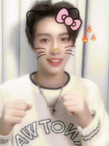 a young man wearing a hello kitty face mask is making a face .