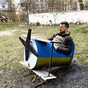 a man is sitting in a chair made out of a barrel with a propeller