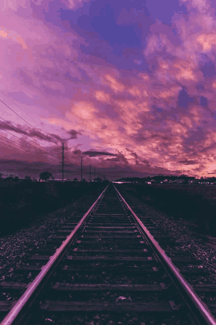 train tracks with a sunset in the background