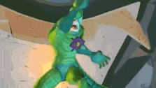 a green superhero with a purple star on his chest is standing in front of a wall .