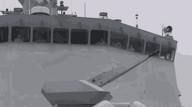 a black and white photo of a large ship with a crane attached to the side