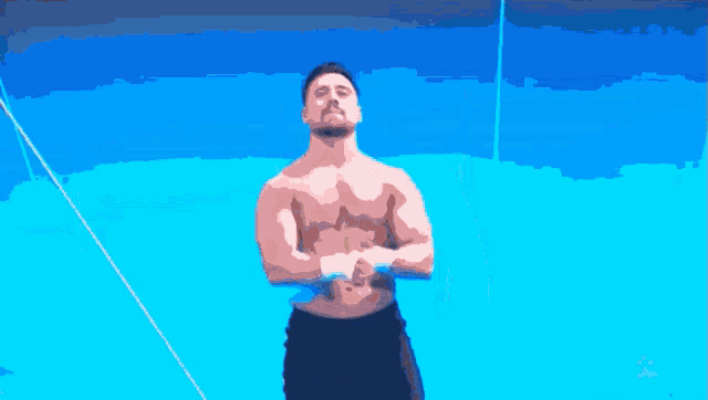 a shirtless man is standing in front of a blue sky