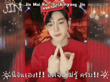 a man wearing a red hat and a red sweater is making a heart with his fingers