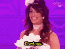 a woman in a wedding dress is saying `` thank you '' .