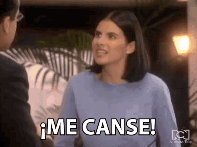 a woman in a blue shirt is talking to a man and says me canse