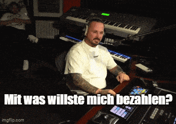 a man wearing headphones sits in front of a keyboard with the words mit was willste mich bezahlen