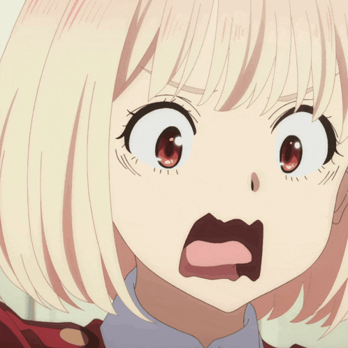 a close up of a girl 's face with her mouth open