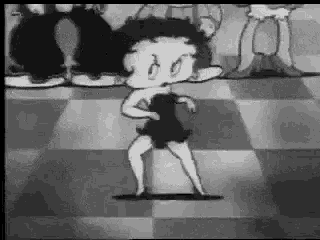 betty boop is dancing on a checkered floor in a black and white photo .