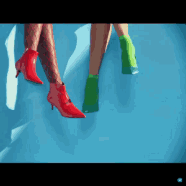 a pair of women 's legs wearing red and green shoes on a blue background
