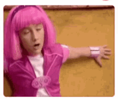 a girl with pink hair is giving a thumbs down .