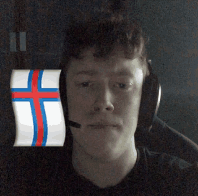 a man wearing headphones has a cross on his head