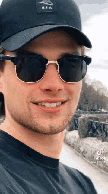 a man wearing sunglasses and a hat with the word nike on it