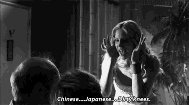 a black and white photo of a woman making a funny face and saying chinese ... japanese ... dirty knees .