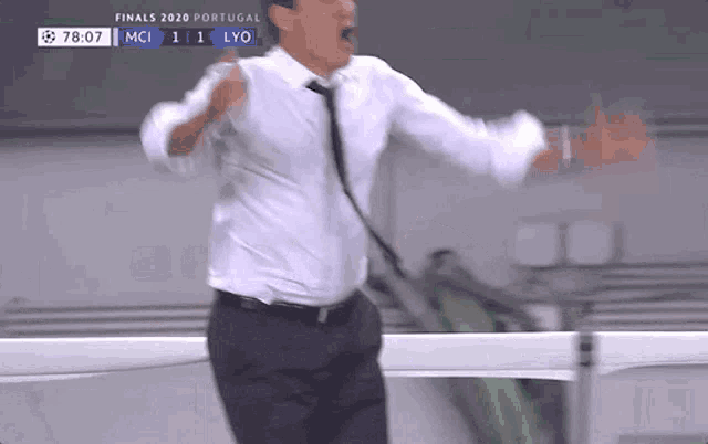 a man in a white shirt and black tie is standing in front of a scoreboard that says finals 2020 portugal