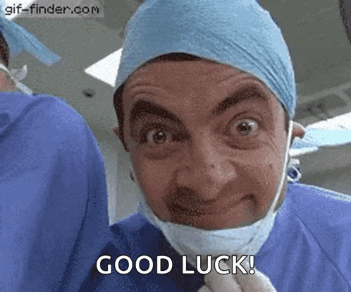 mr bean is wearing a surgical mask and a surgical cap .