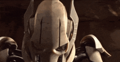 a close up of a robot 's face with a dark background .