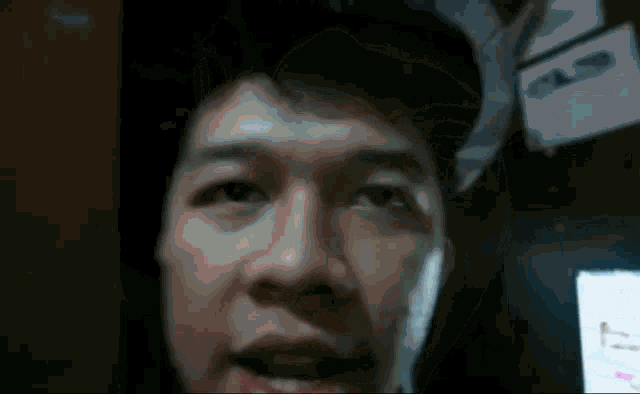 a close up of a man 's face with a sign behind him that says ' a '