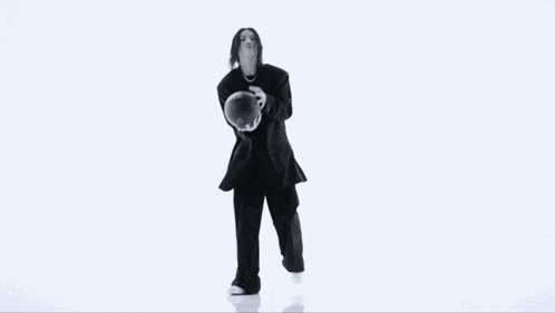 a black and white photo of a woman in a suit dancing