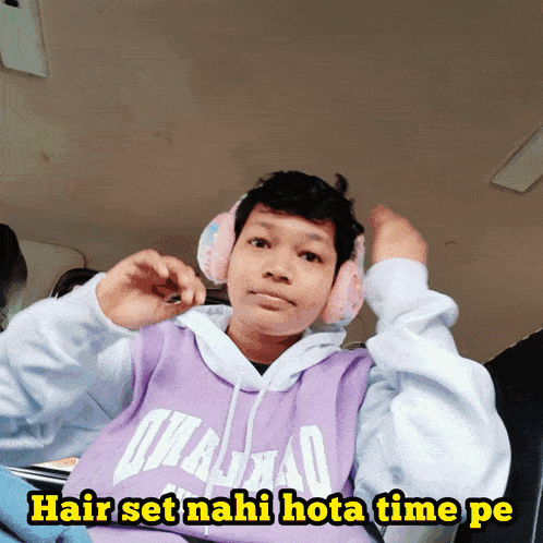 a boy wearing headphones and a purple hoodie with the words hair set nahi mota time pe