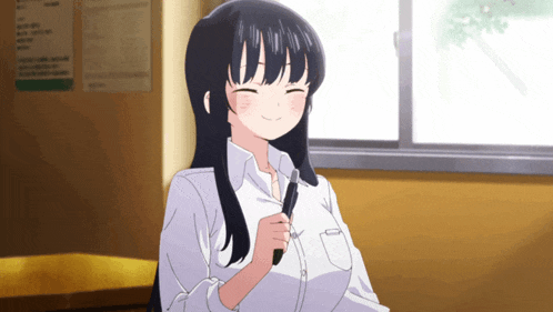 a girl with long black hair is sitting in front of a window and smiling