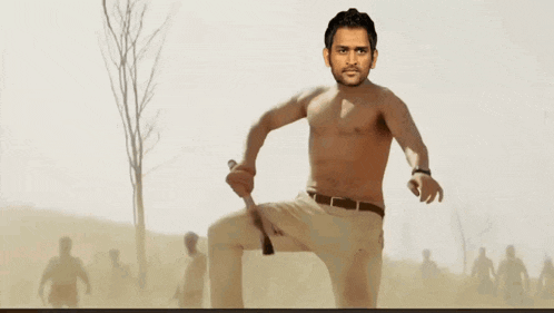 a man without a shirt is holding a sword in his hand