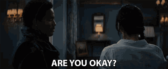 a man and a woman are looking at each other with the words " are you okay " on the bottom