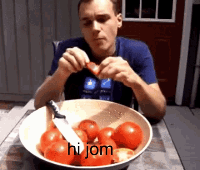 a man is cutting a tomato in front of a bowl of tomatoes that says hi jom on the bottom