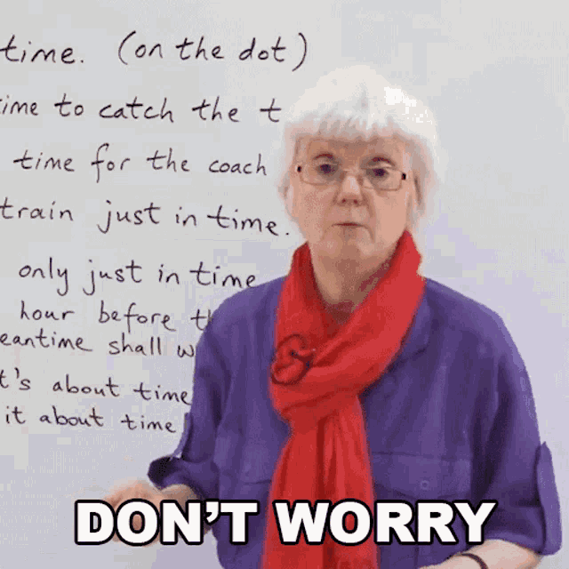 an elderly woman stands in front of a white board that says " time " on it