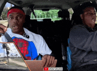 two men are sitting in a car and one is wearing a headband that says nike on it