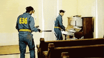 a man in a blue jumpsuit with the number 636 on the back