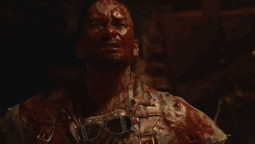 a man with blood on his face is holding a hammer