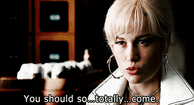 a woman says " you should so totally come " in front of a chess board