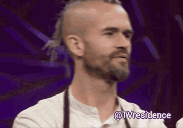 a man with a beard and a mohawk has the hashtag @tvresidence written below him