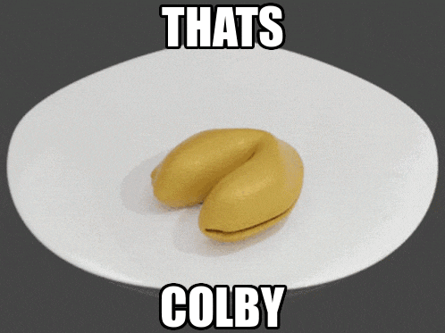a yellow fortune cookie on a white plate with the words that 's colby below it