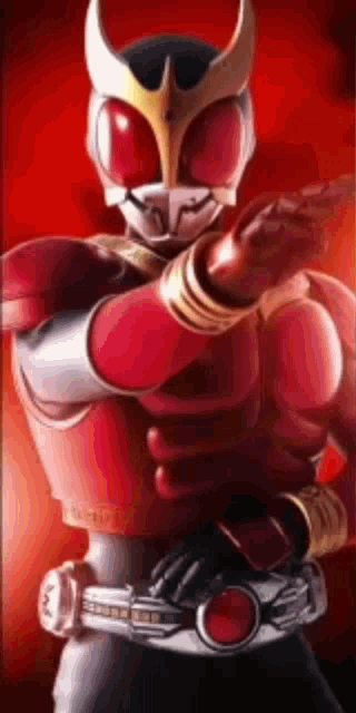 a man in a red and gold superhero costume is holding a gun in his hand .