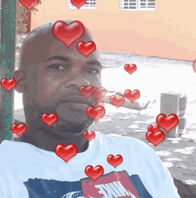 a man wearing a nike t-shirt is surrounded by hearts