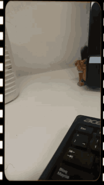 a black acer keyboard sits on a desk