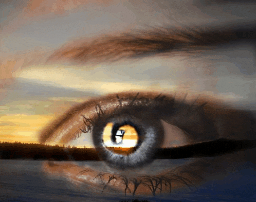 a close up of a woman 's eye with the letter g in the center