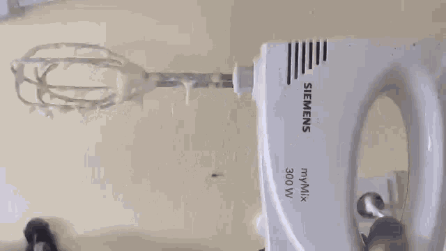 a siemens hand mixer with whipped cream on the beaters
