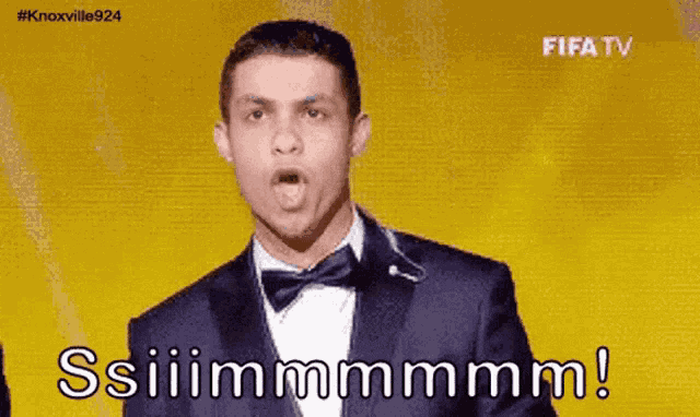 a man in a suit and bow tie says ssiiimmmmm