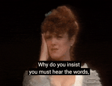 a woman is crying on a stage and covering her face with her hands .