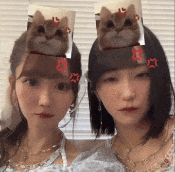 a girl with a cat on her head and another girl with a star on her head