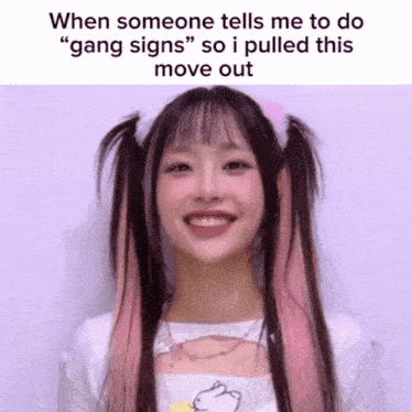 a girl with pigtails is smiling and says when someone tells me to do gang signs