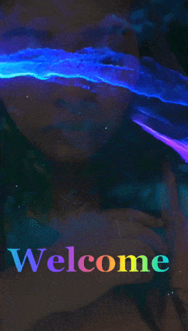 a rainbow colored welcome sign with a woman 's face behind it