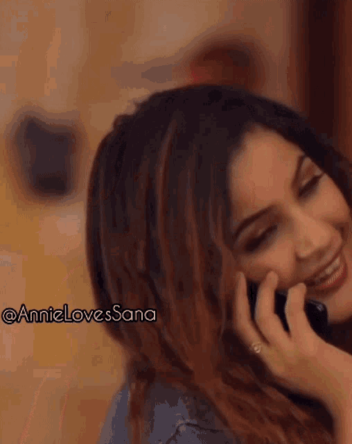 a close up of a woman talking on a cell phone with annie loves sana written in the corner
