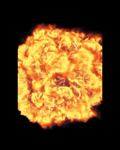 a large explosion of fire is going off in the dark