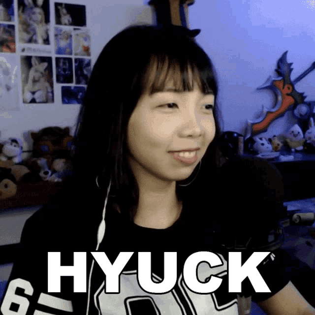 a girl wearing a black shirt that says hyuck on it